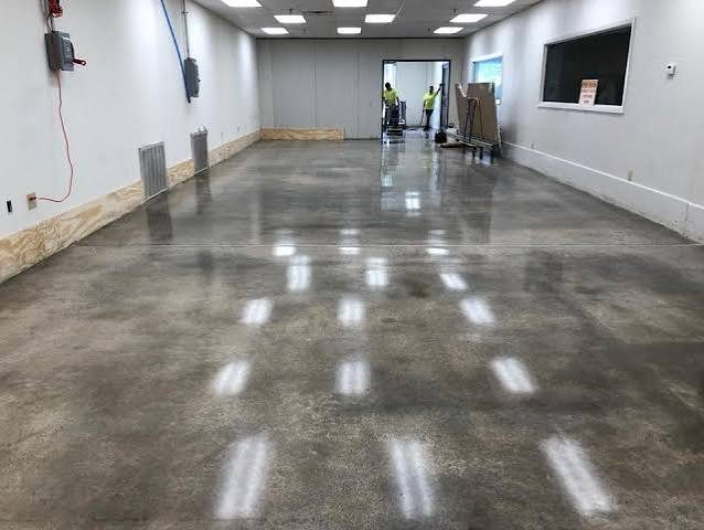 Crew polishing a commercial concrete floor while the space stays accessible