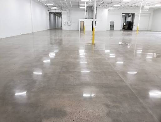 Polished concrete warehouse floor with safety bollards
