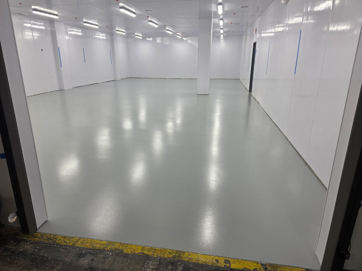 Large renovated commercial interior with gray epoxy floor