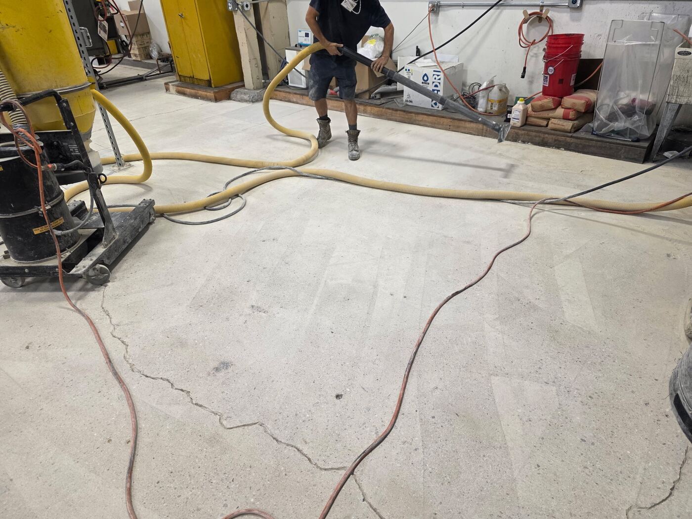 Our crew operating a grinder and dust collection system on a facility floor