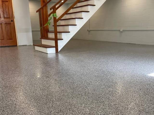 Flake epoxy basement floor beside a wood staircase